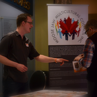 World Vision Canada's Jason Moffat discusses child sponsorship with an attendee.